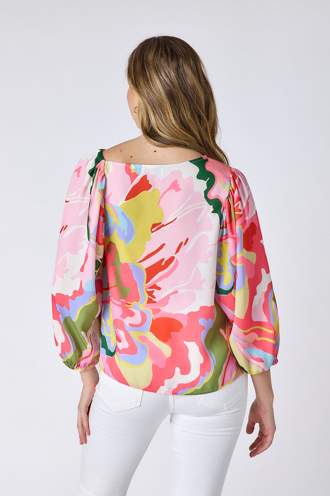 Flutter 3/4 sleeve top with asymmetrical neckline on model — CROSBY by Mollie Burch