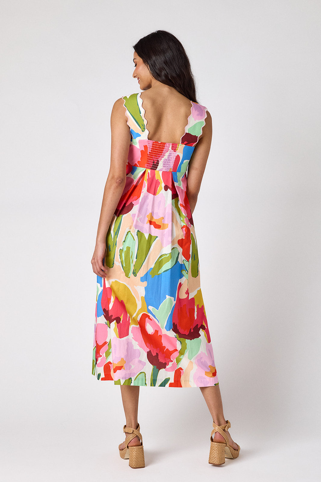Painted Petals midi dress with fitted bodice and wavy straps on model — CROSBY by Mollie Burch