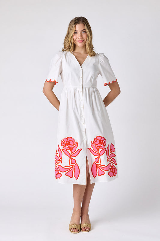 Ivory cotton button-down midi dress with scalloped sleeves and pink and red embroidery on model — CROSBY by Mollie Burch