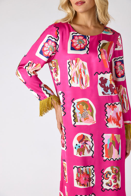 Woman wearing a bright pink dress with colorful abstract patterns on a white background