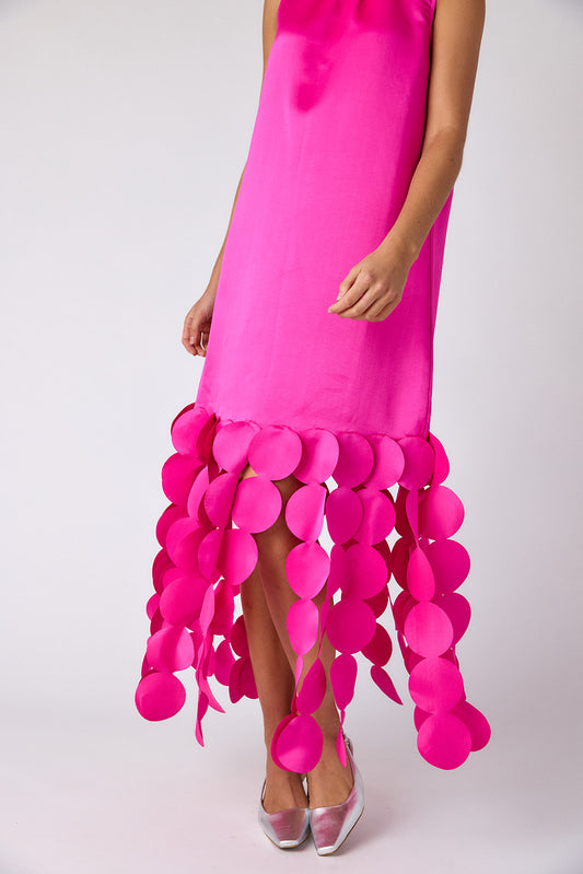 Pink dress with a unique skirt design on a white background