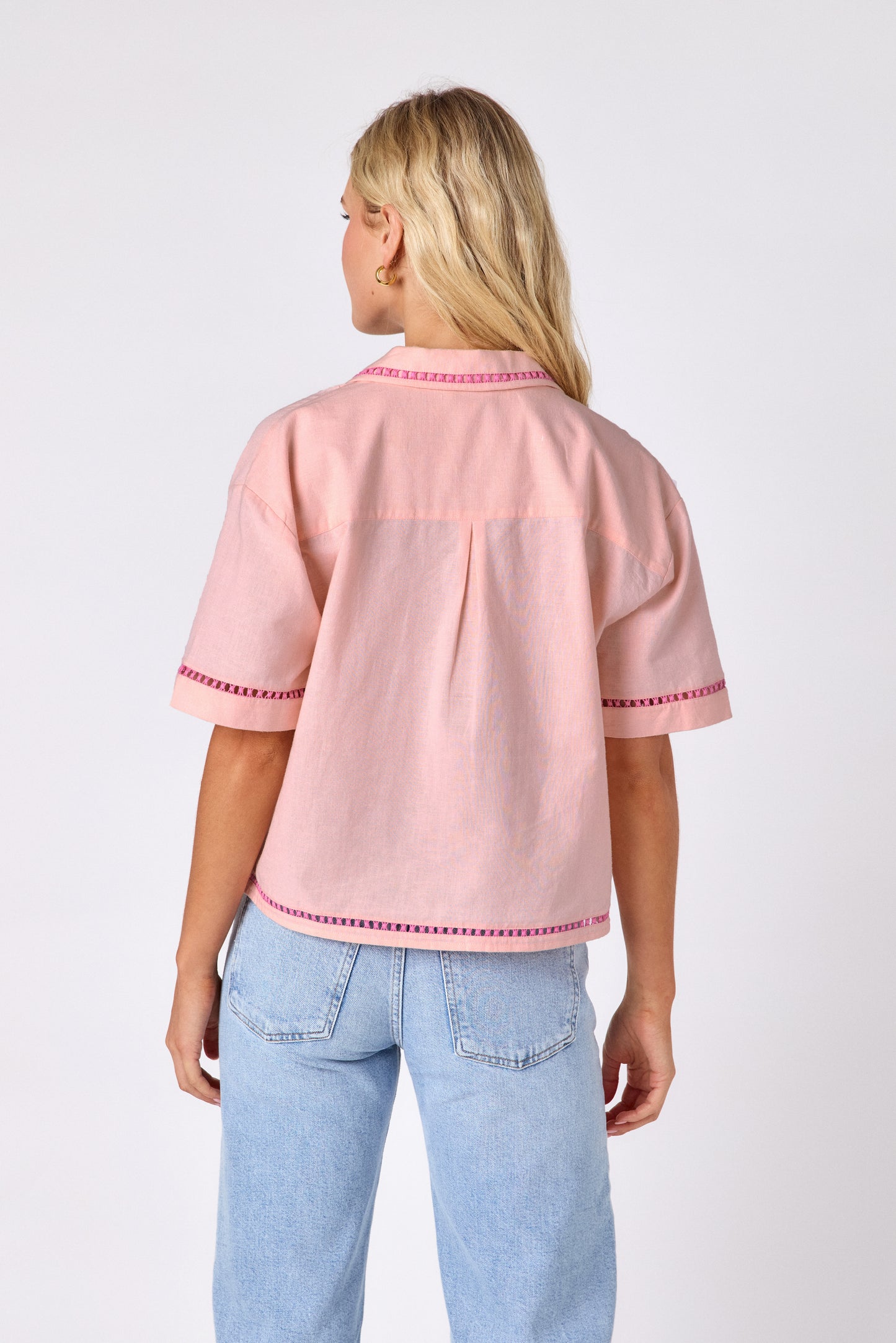 Orange Crush short sleeve collared buttondown with orange embroidery detail on model — CROSBY by Mollie Burch