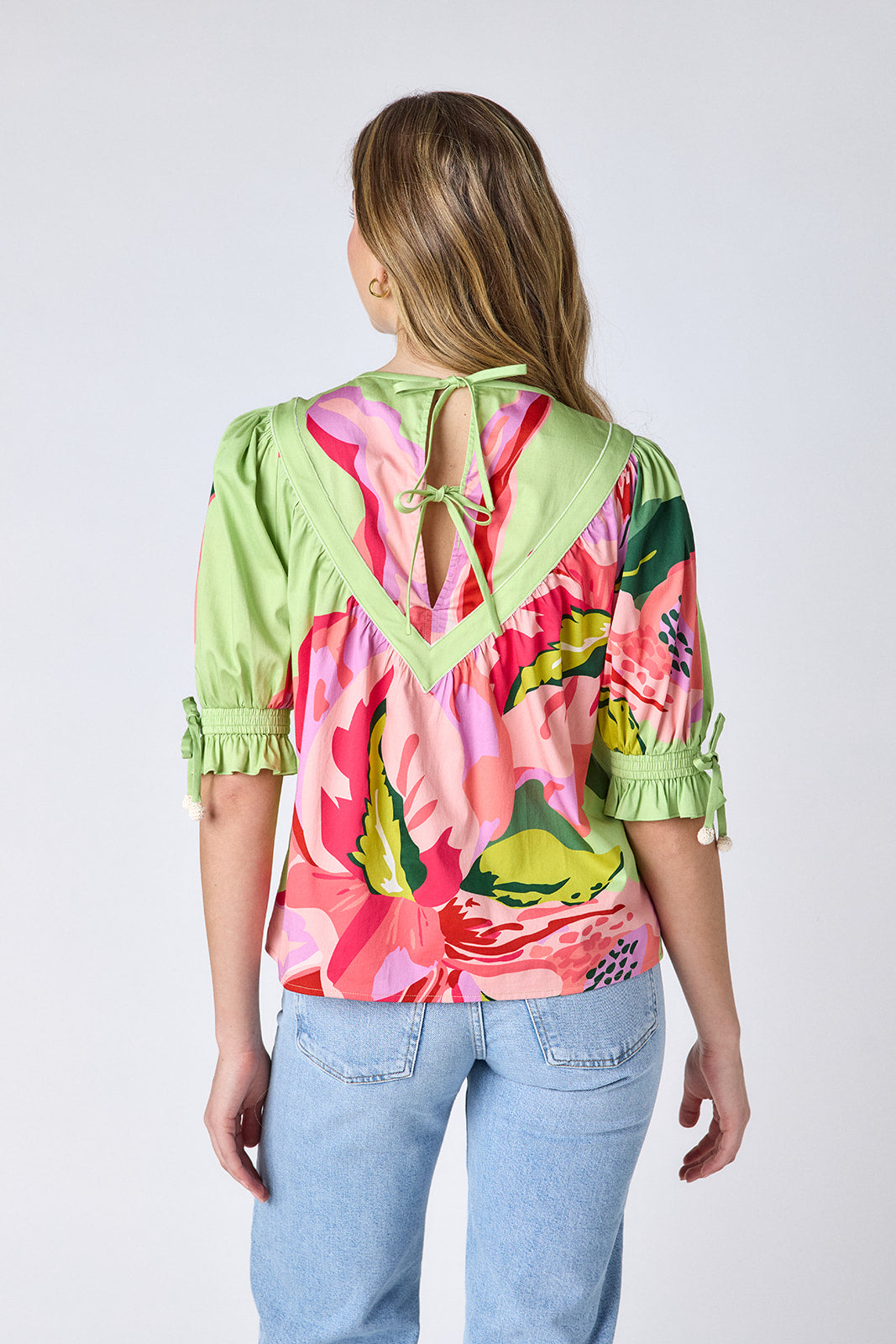 Orchid puff sleeve top with tie detail on model — CROSBY by Mollie Burch