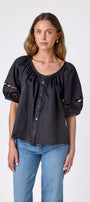 Black button front top with balloon sleeves and fagoting detail on model — CROSBY by Mollie Burch