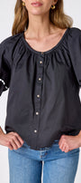 Black button front top with balloon sleeves and fagoting detail on model — CROSBY by Mollie Burch