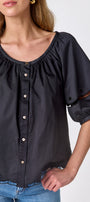 Black button front top with balloon sleeves and fagoting detail on model — CROSBY by Mollie Burch