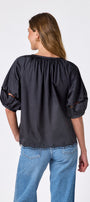 Black button front top with balloon sleeves and fagoting detail on model — CROSBY by Mollie Burch