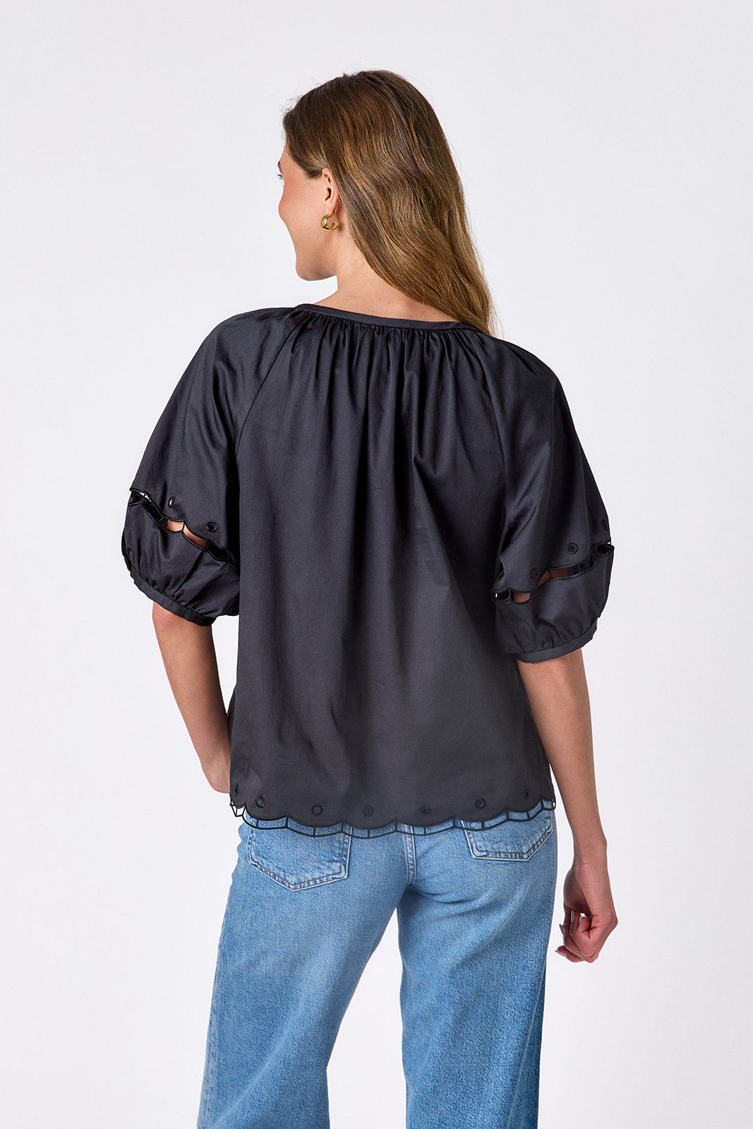 Black button front top with balloon sleeves and fagoting detail on model — CROSBY by Mollie Burch