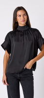 Black Lillian Top with short sleeves and versatile scarf detailing on model – CROSBY by Mollie Burch