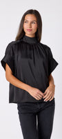 Black Lillian Top with short sleeves and versatile scarf detailing on model – CROSBY by Mollie Burch