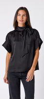 Black Lillian Top with short sleeves and versatile scarf detailing on model – CROSBY by Mollie Burch