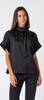 Black Lillian Top with short sleeves and versatile scarf detailing on model – CROSBY by Mollie Burch