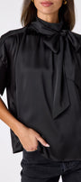 Black Lillian Top with short sleeves and versatile scarf detailing on model – CROSBY by Mollie Burch