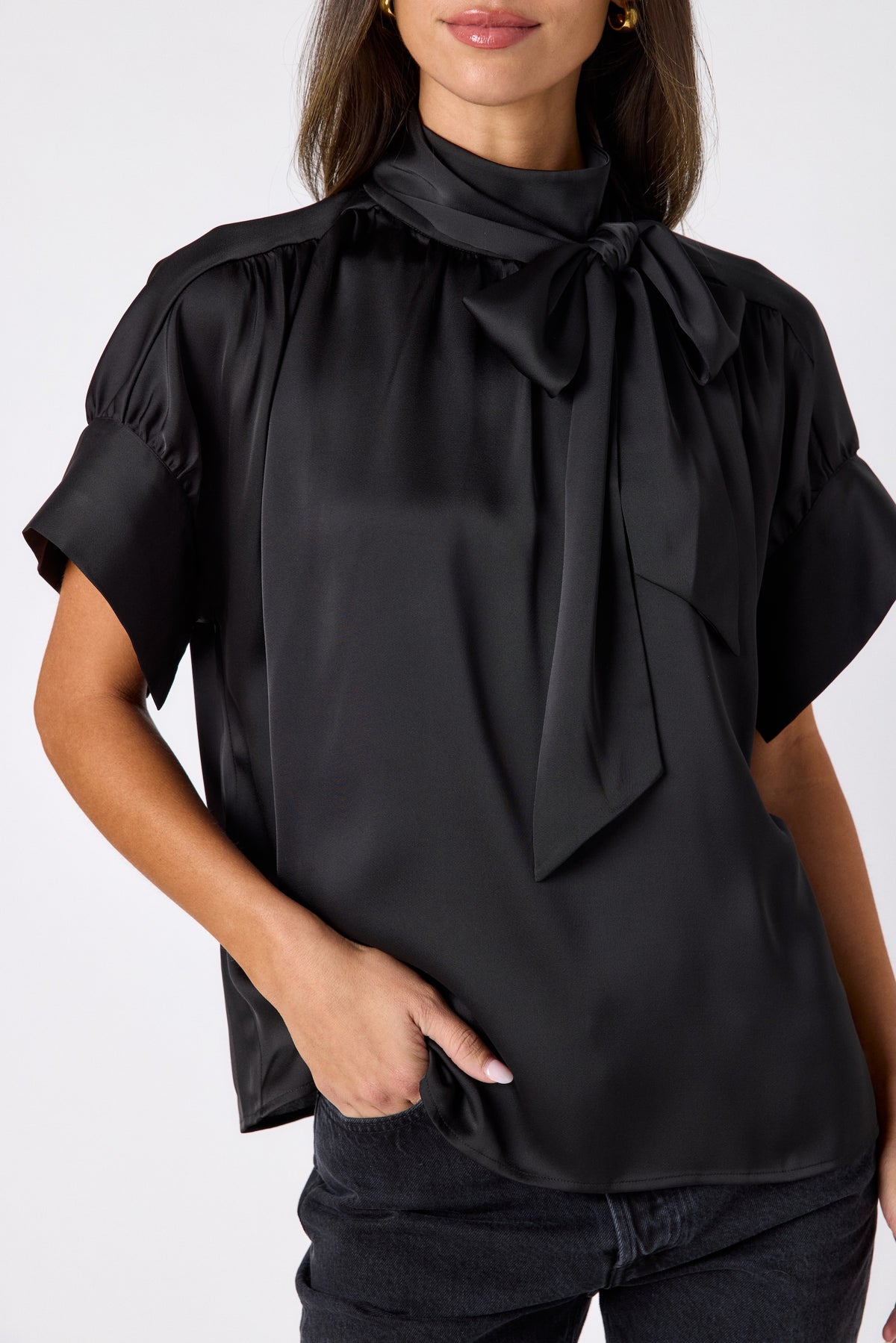 Black Lillian Top with short sleeves and versatile scarf detailing on model – CROSBY by Mollie Burch