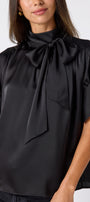 Black Lillian Top with short sleeves and versatile scarf detailing on model – CROSBY by Mollie Burch