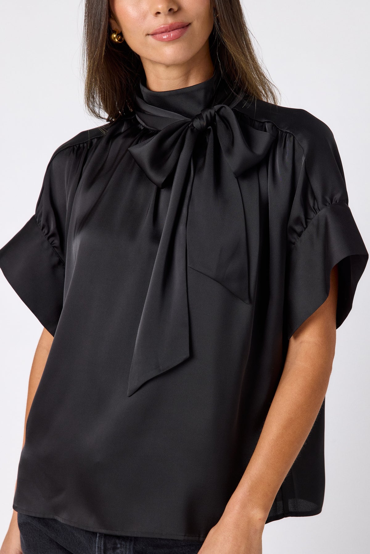 Black Lillian Top with short sleeves and versatile scarf detailing on model – CROSBY by Mollie Burch