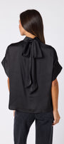 Black Lillian Top with short sleeves and versatile scarf detailing on model – CROSBY by Mollie Burch
