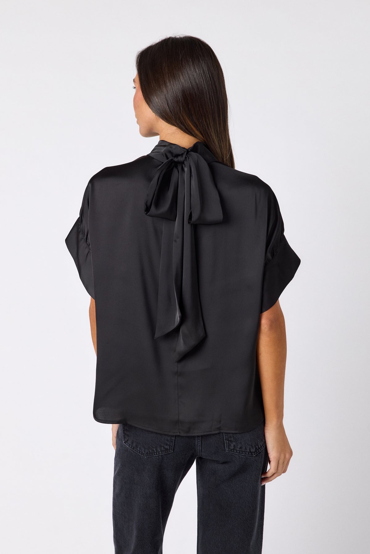 Black Lillian Top with short sleeves and versatile scarf detailing on model – CROSBY by Mollie Burch