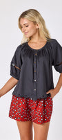 Black button front top with balloon sleeves and fagoting detail with Pheasant short on model — CROSBY by Mollie Burch