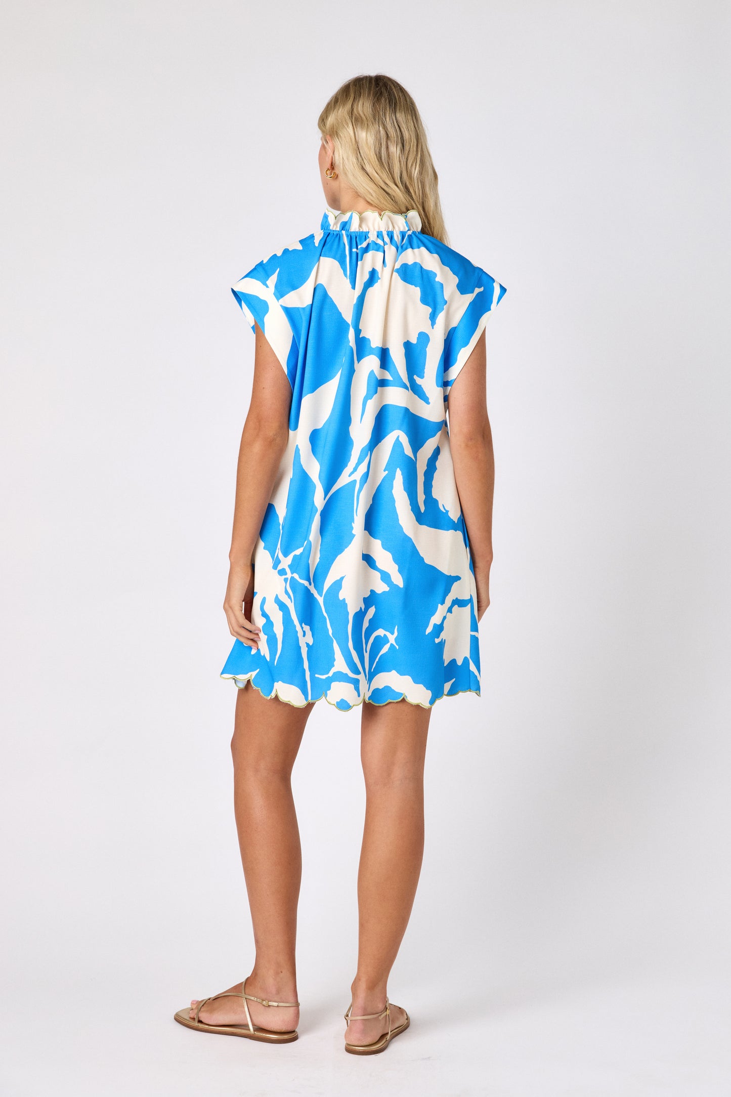 Blue Fern button-front mini dress with scallop hem on model — CROSBY by Mollie Burch