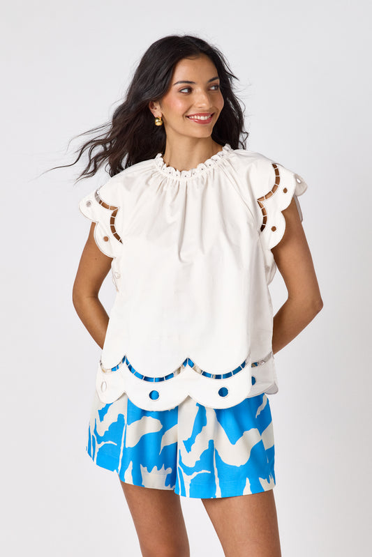 Cream raglan style short sleeve top with fagoting and scallop details on model — CROSBY by Mollie Burch