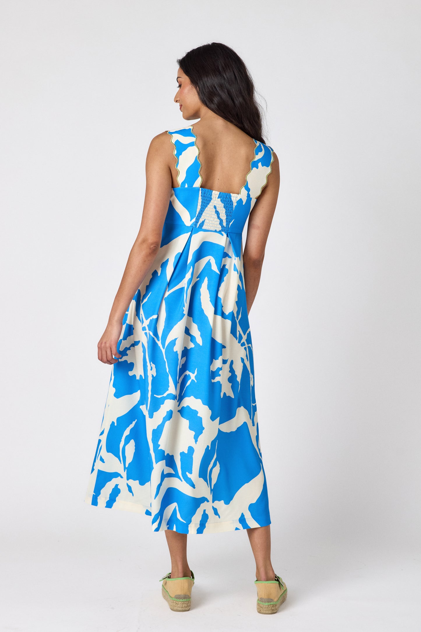 Blue Fern midi dress with fitted bodice and wavy straps on model — CROSBY by Mollie Burch