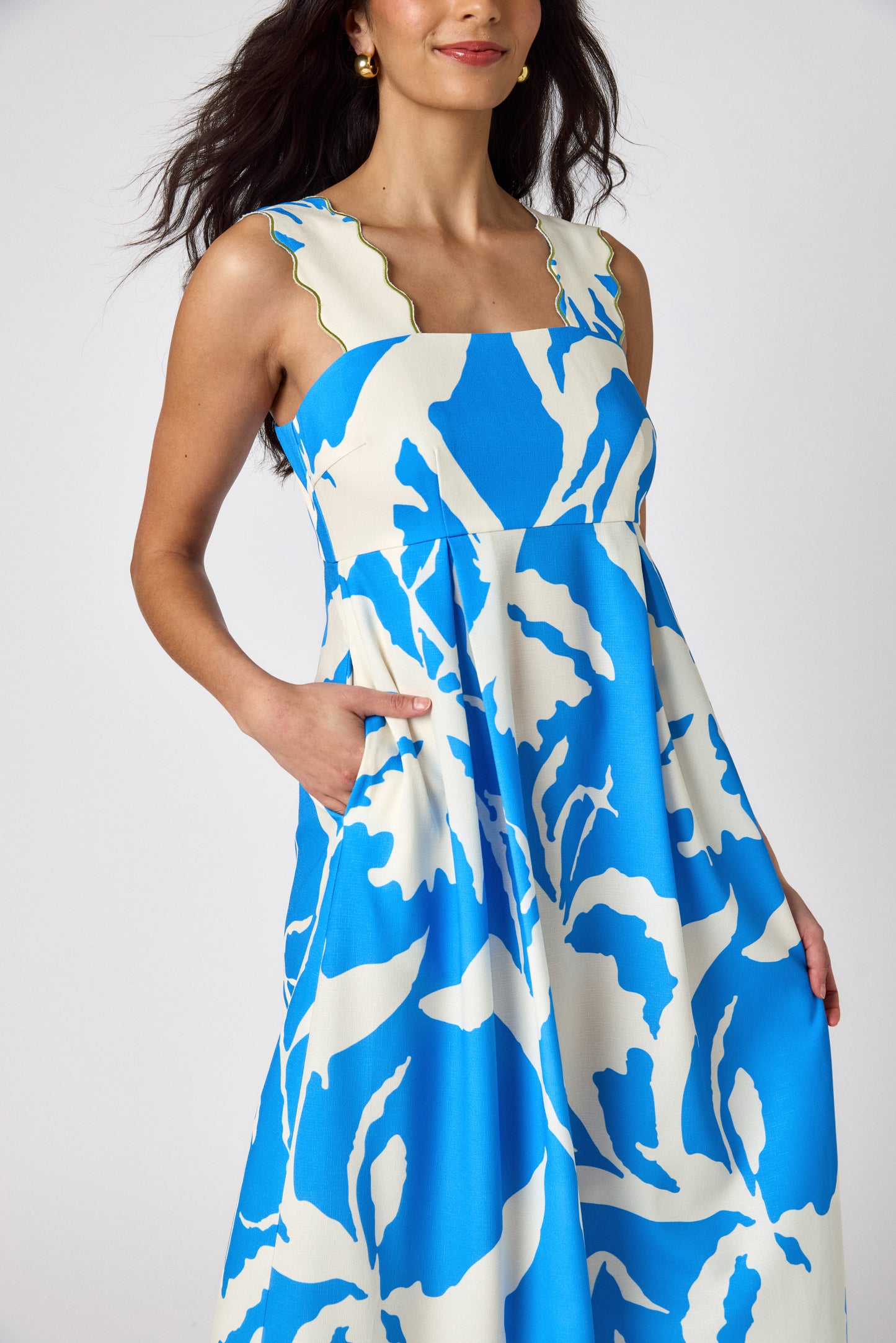 Blue Fern midi dress with fitted bodice and wavy straps on model — CROSBY by Mollie Burch