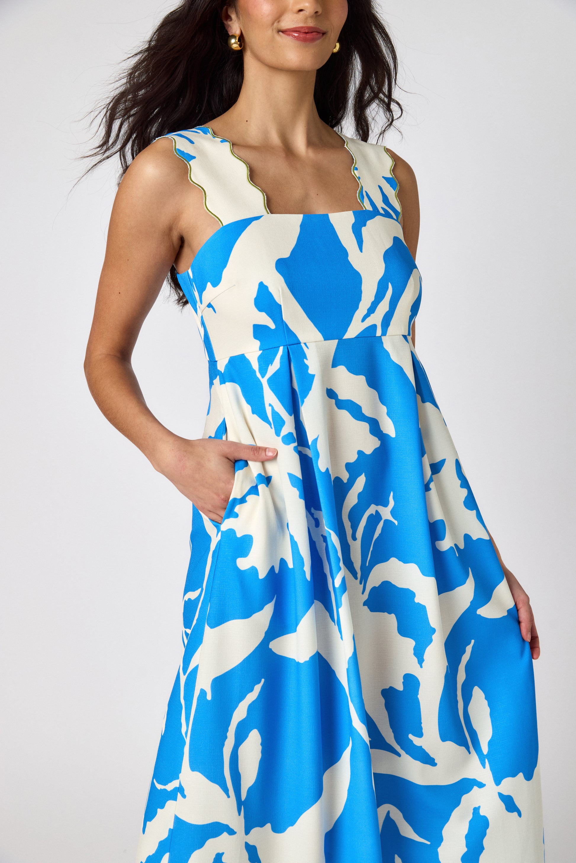 Blue Fern midi dress with fitted bodice and wavy straps on model — CROSBY by Mollie Burch