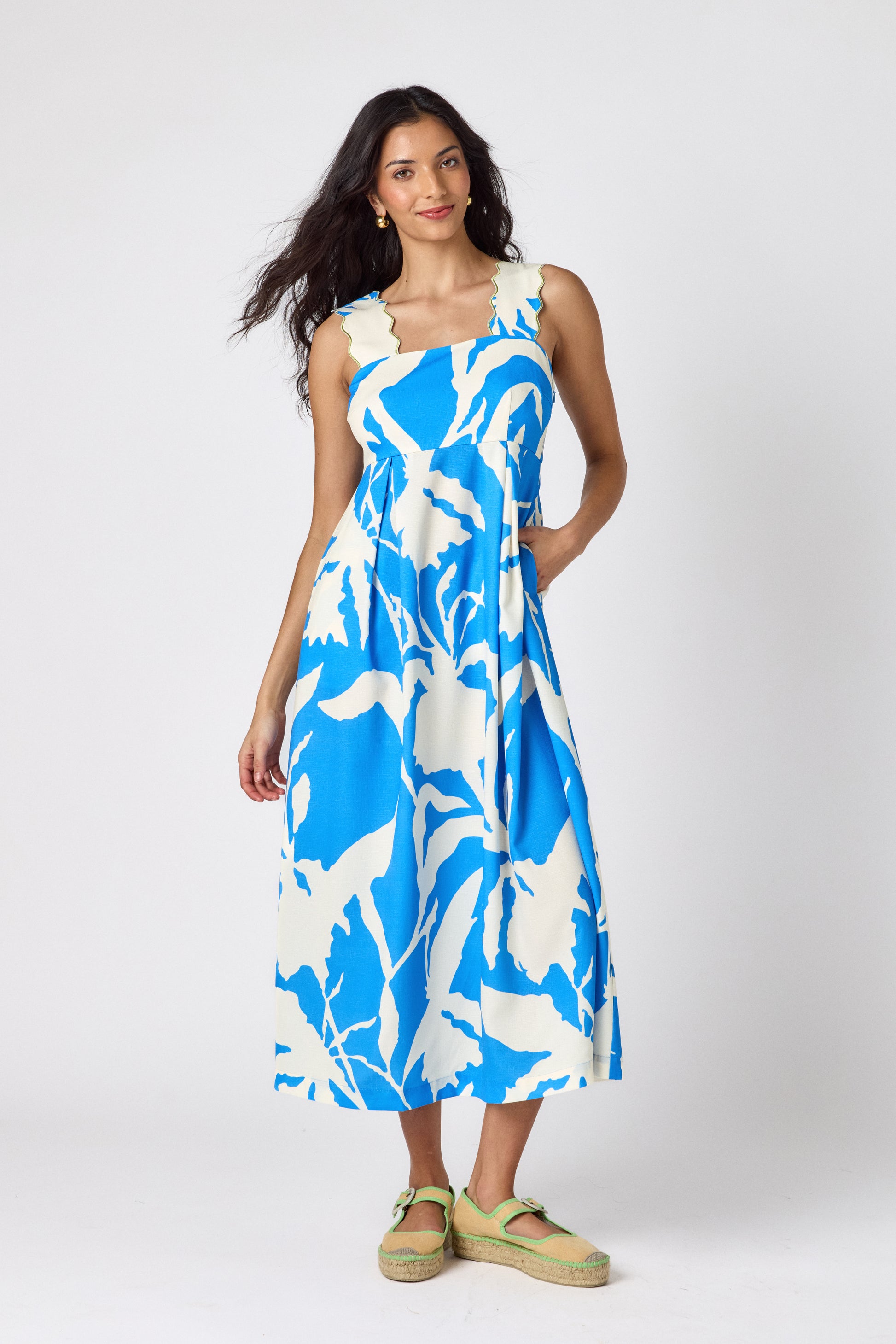 Blue Fern midi dress with fitted bodice and wavy straps on model — CROSBY by Mollie Burch