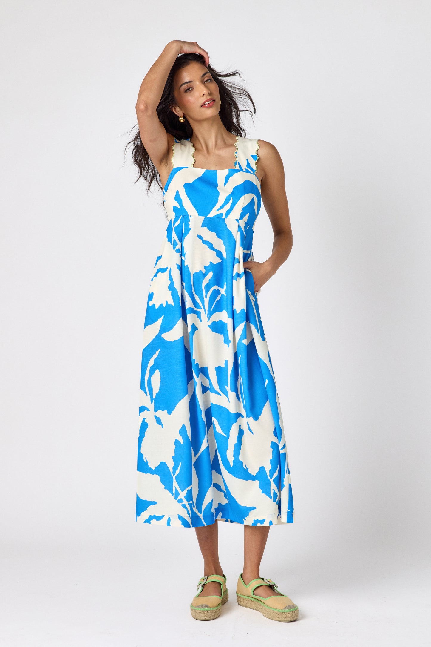 Blue Fern midi dress with fitted bodice and wavy straps on model — CROSBY by Mollie Burch