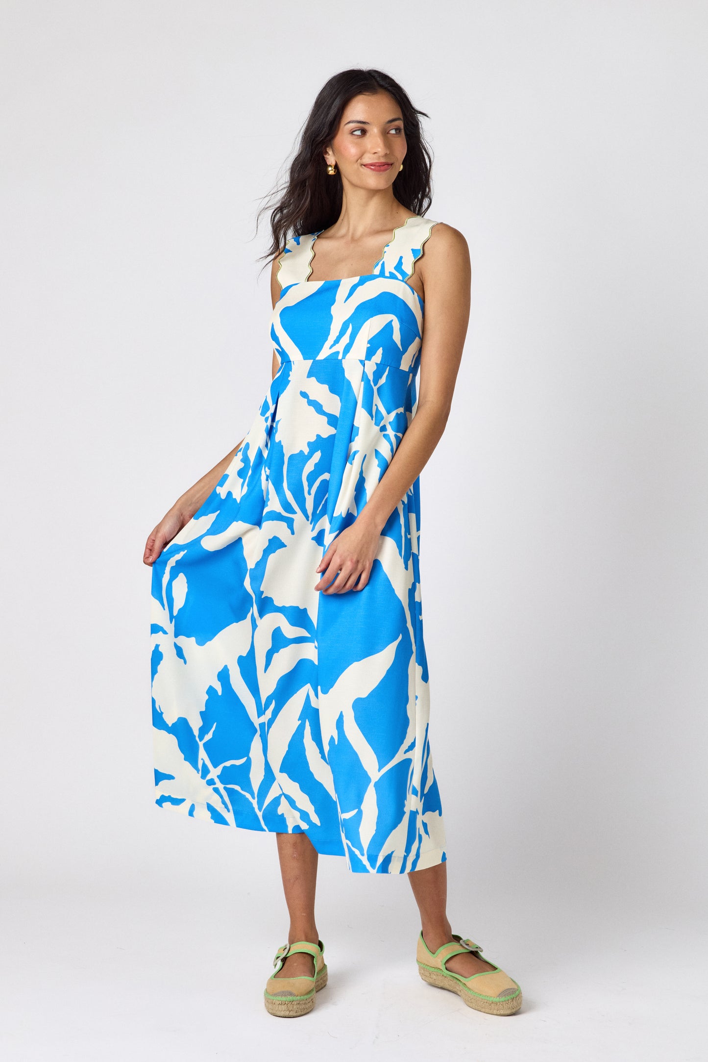 Blue Fern midi dress with fitted bodice and wavy straps on model — CROSBY by Mollie Burch
