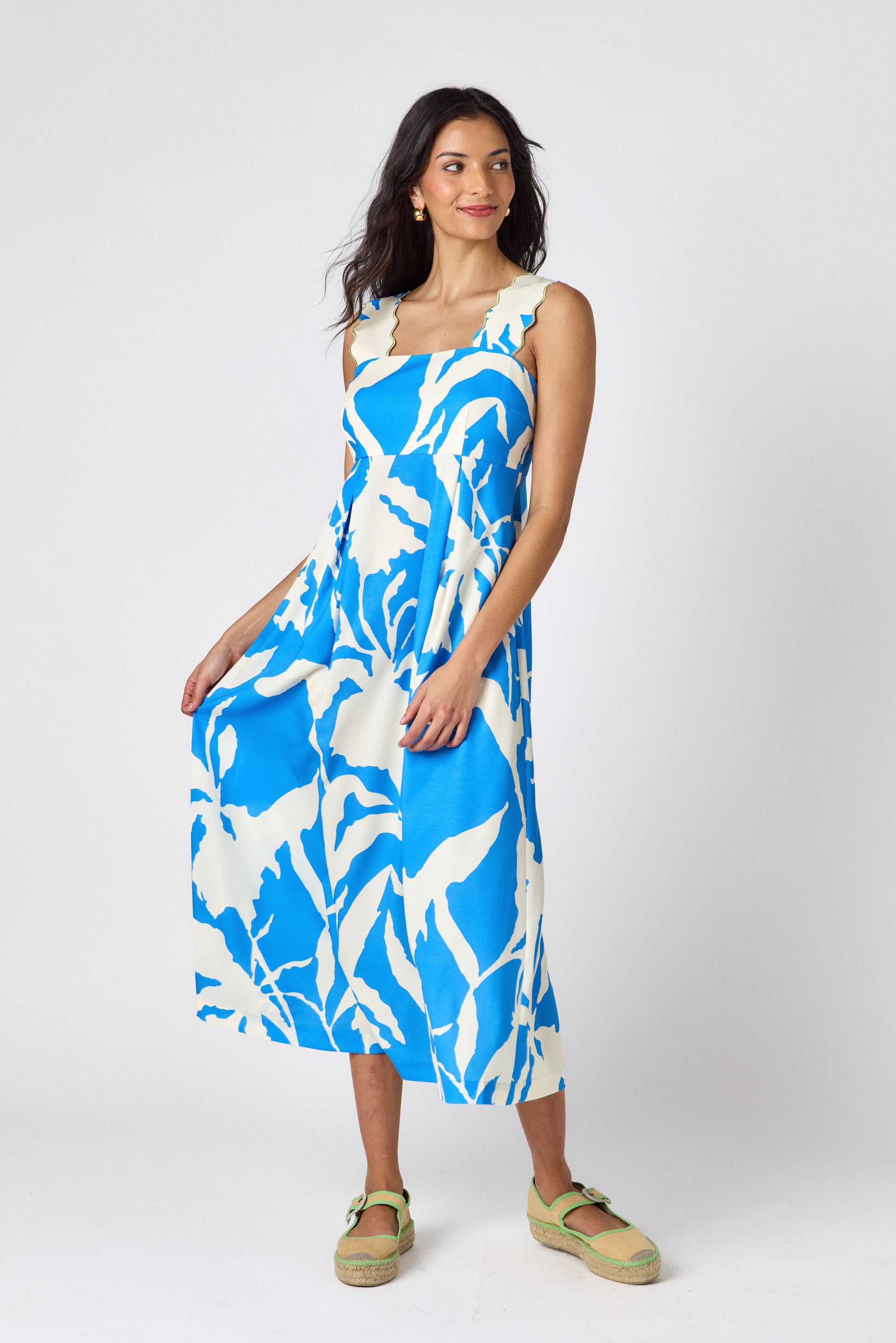 Blue Fern midi dress with fitted bodice and wavy straps on model — CROSBY by Mollie Burch