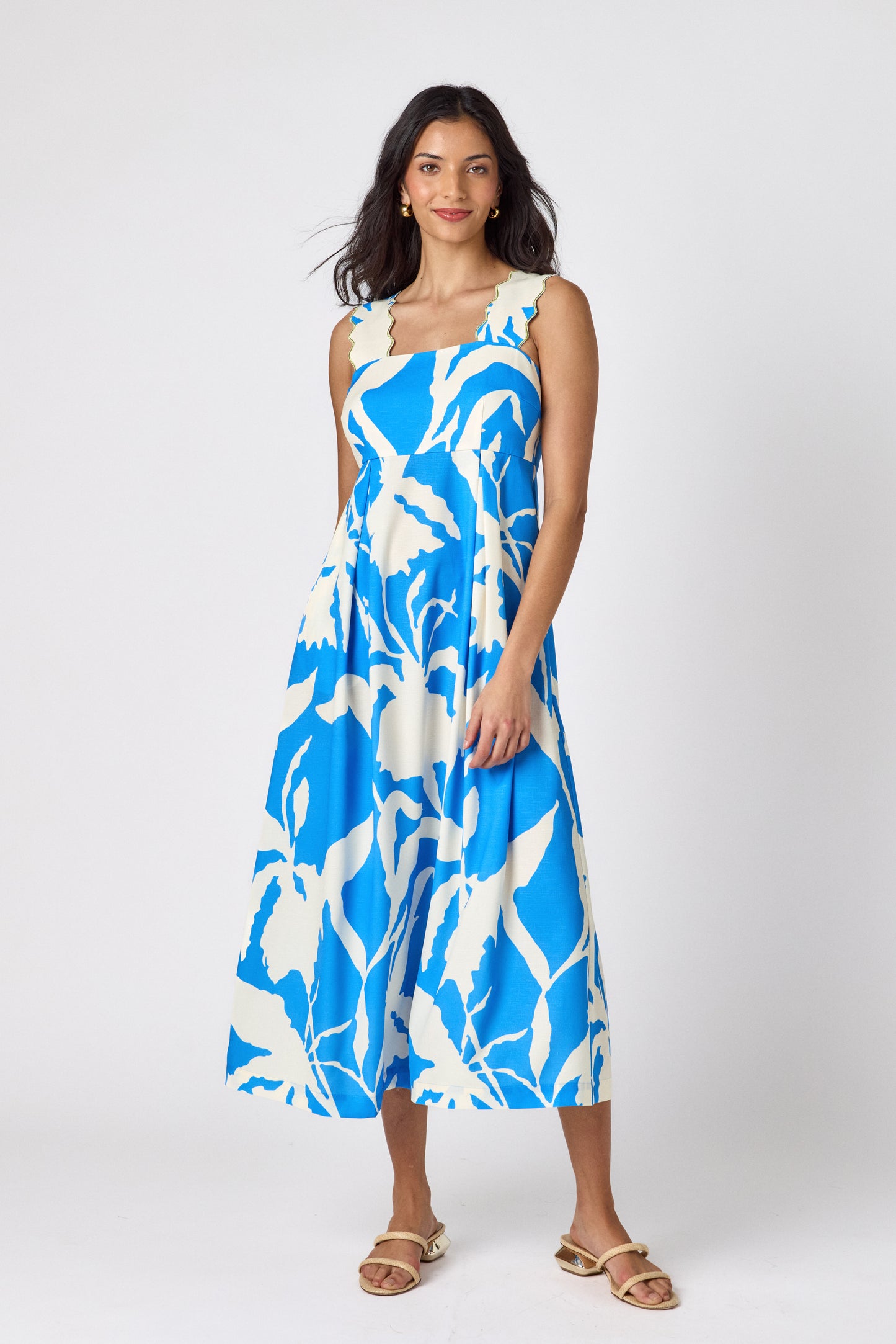 Blue Fern midi dress with fitted bodice and wavy straps on model — CROSBY by Mollie Burch