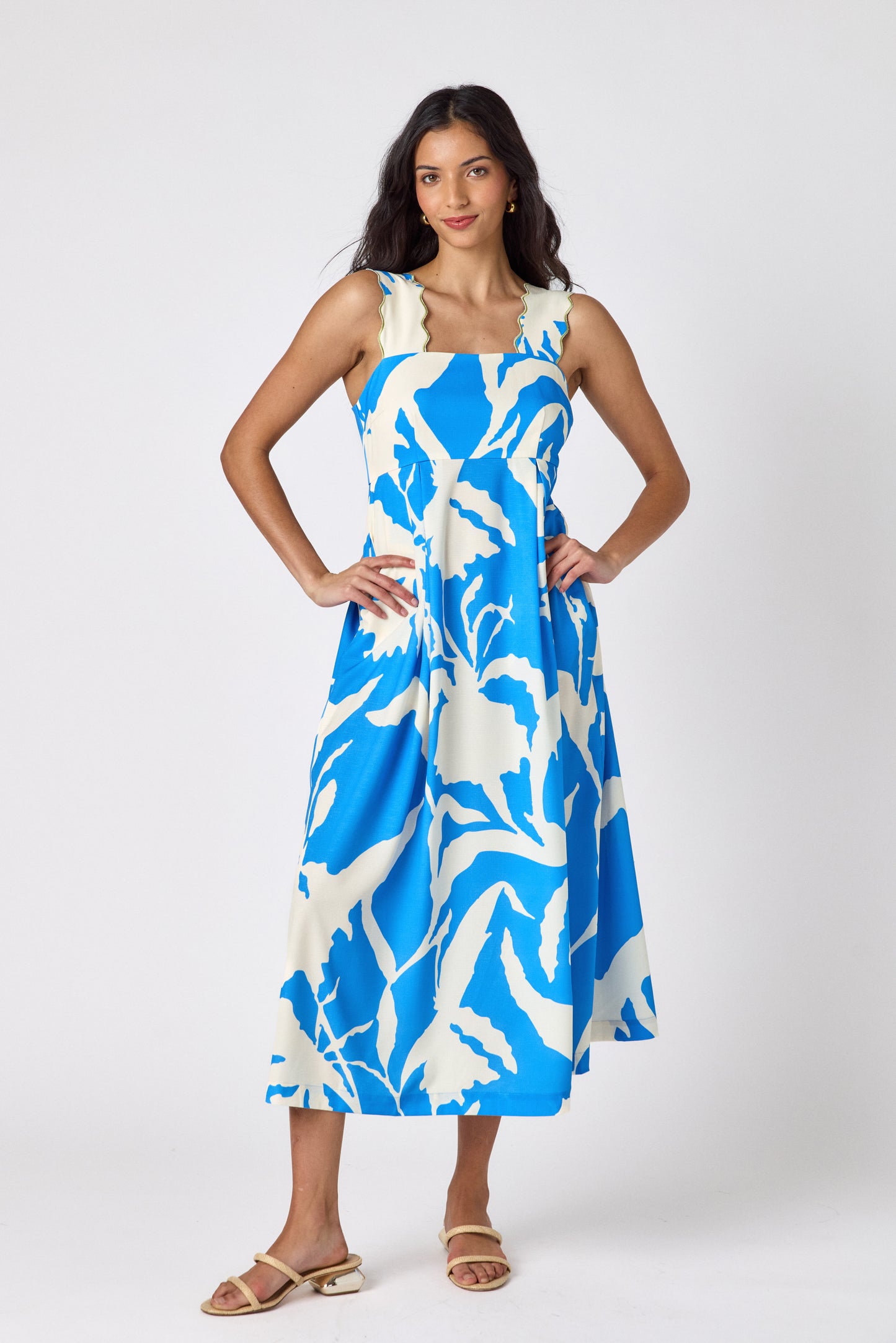 Blue Fern midi dress with fitted bodice and wavy straps on model — CROSBY by Mollie Burch