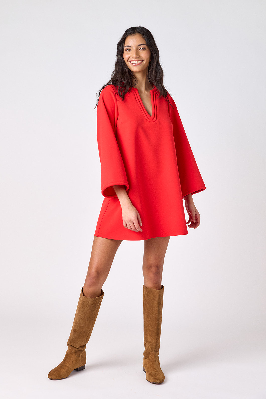 Carnelian above-the-knee tunic dress with bell sleeves on model – CROSBY by Mollie Burch