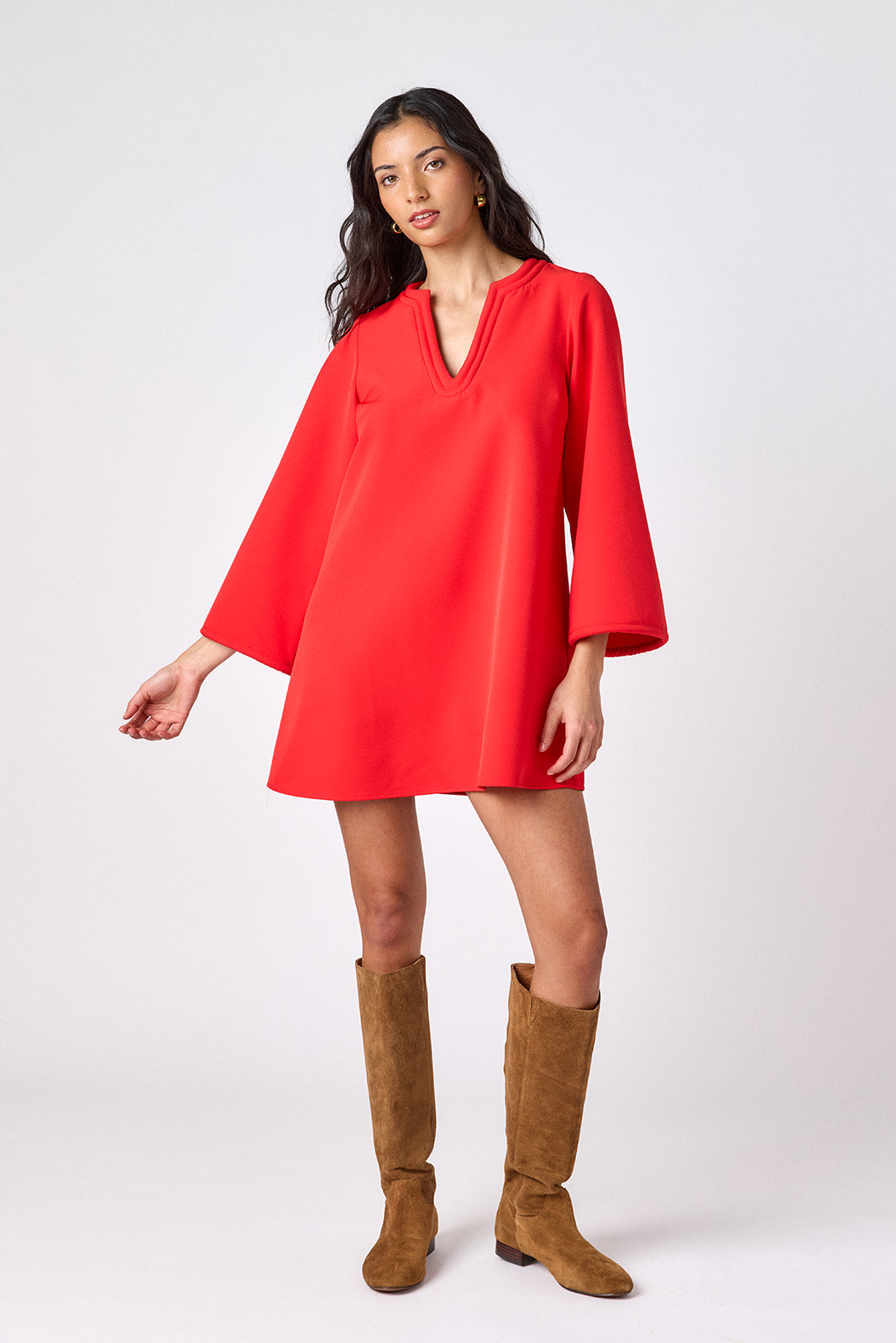 Carnelian above-the-knee tunic dress with bell sleeves on model – CROSBY by Mollie Burch