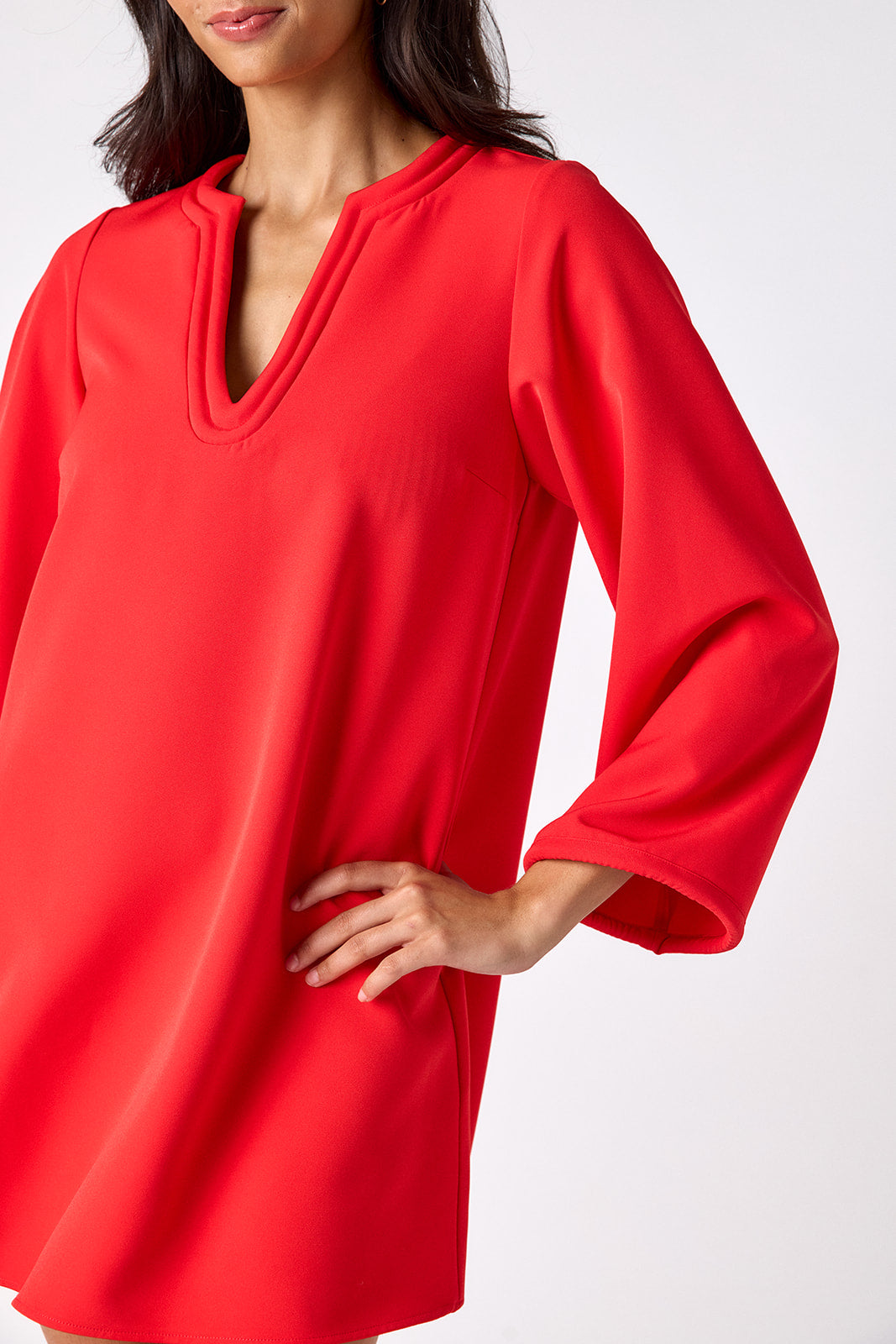 Carnelian above-the-knee tunic dress with bell sleeves on model – CROSBY by Mollie Burch