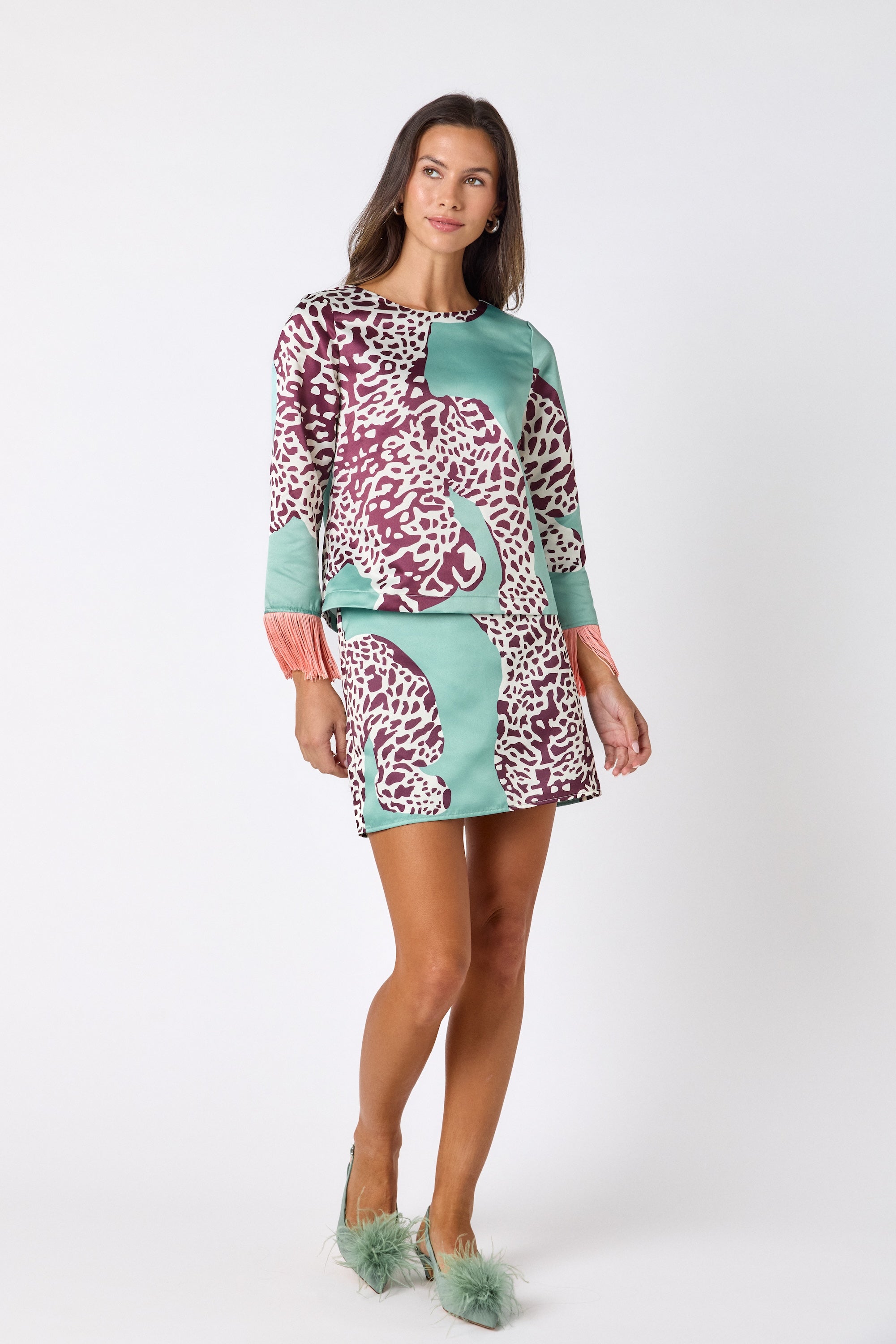 Penny Mini Skirt in Mint Catwalk featuring a bold animal-inspired print on model – CROSBY by Mollie Burch