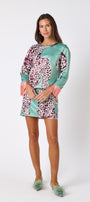 Penny Mini Skirt in Mint Catwalk featuring a bold animal-inspired print on model – CROSBY by Mollie Burch