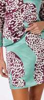 Penny Mini Skirt in Mint Catwalk featuring a bold animal-inspired print on model – CROSBY by Mollie Burch
