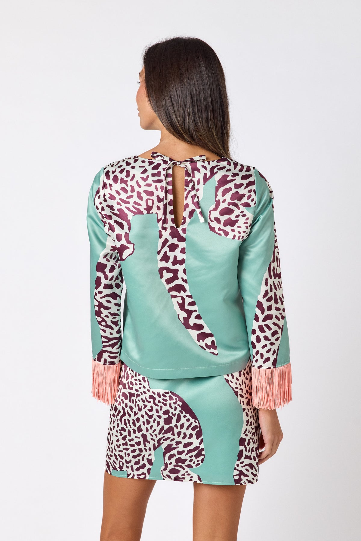 Penny Mini Skirt in Mint Catwalk featuring a bold animal-inspired print on model – CROSBY by Mollie Burch