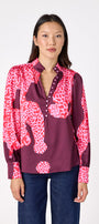 Leland Blouse in Pink Catwalk featuring puff sleeves and gold-rimmed buttons on model – CROSBY by Mollie Burch