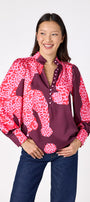 Leland Blouse in Pink Catwalk featuring puff sleeves and gold-rimmed buttons on model – CROSBY by Mollie Burch