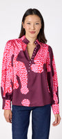 Leland Blouse in Pink Catwalk featuring puff sleeves and gold-rimmed buttons on model – CROSBY by Mollie Burch