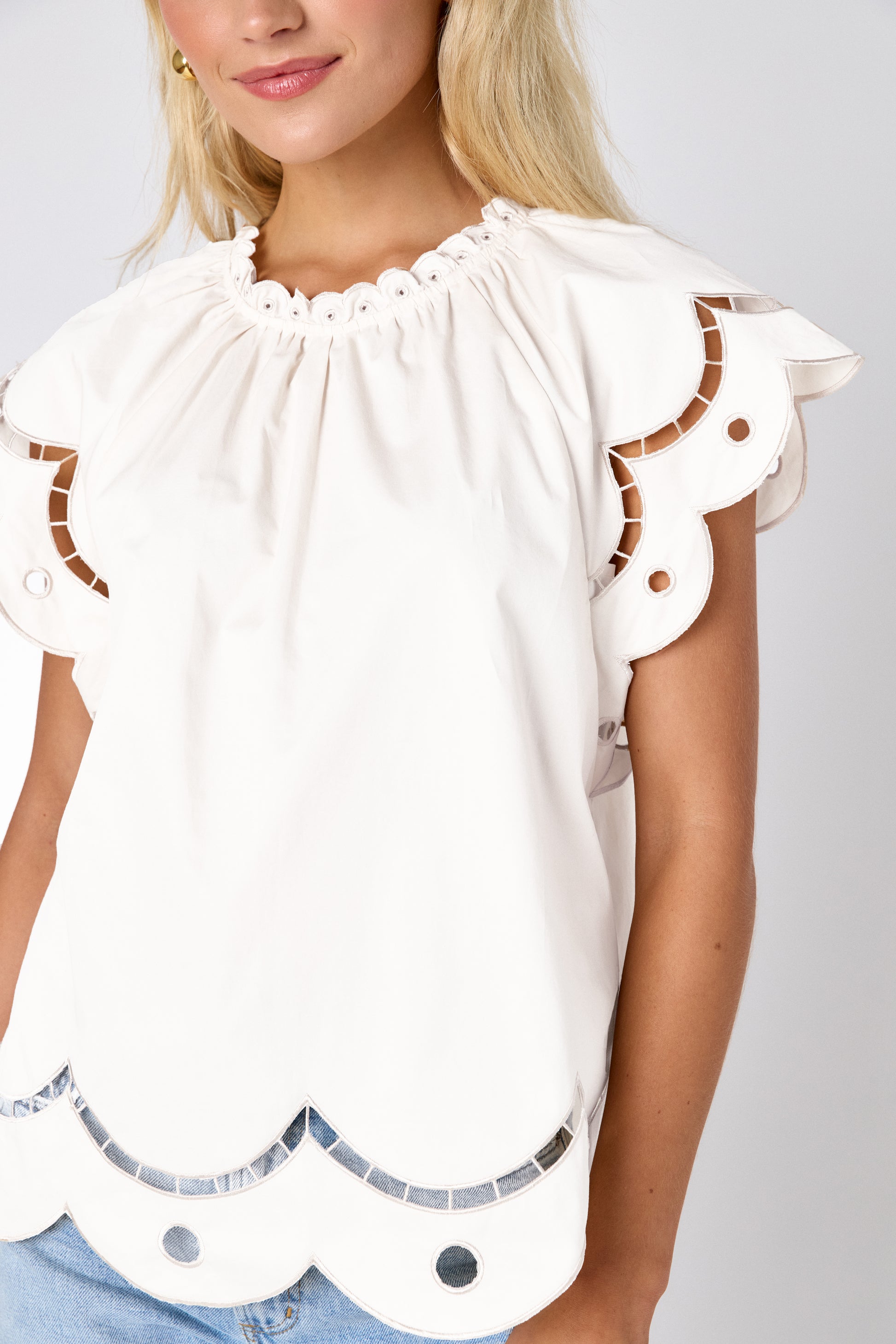 Cream raglan style short sleeve top with fagoting and scallop details on model — CROSBY by Mollie Burch