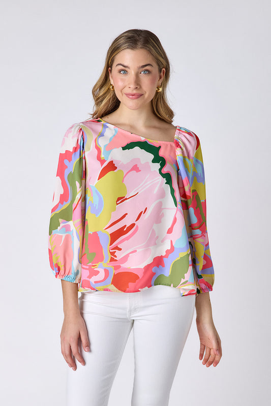 Flutter 3/4 sleeve top with asymmetrical neckline on model — CROSBY by Mollie Burch