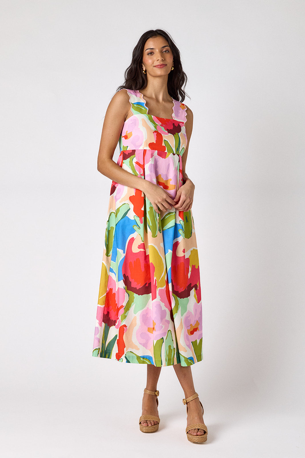 Painted Petals midi dress with fitted bodice and wavy straps on model — CROSBY by Mollie Burch