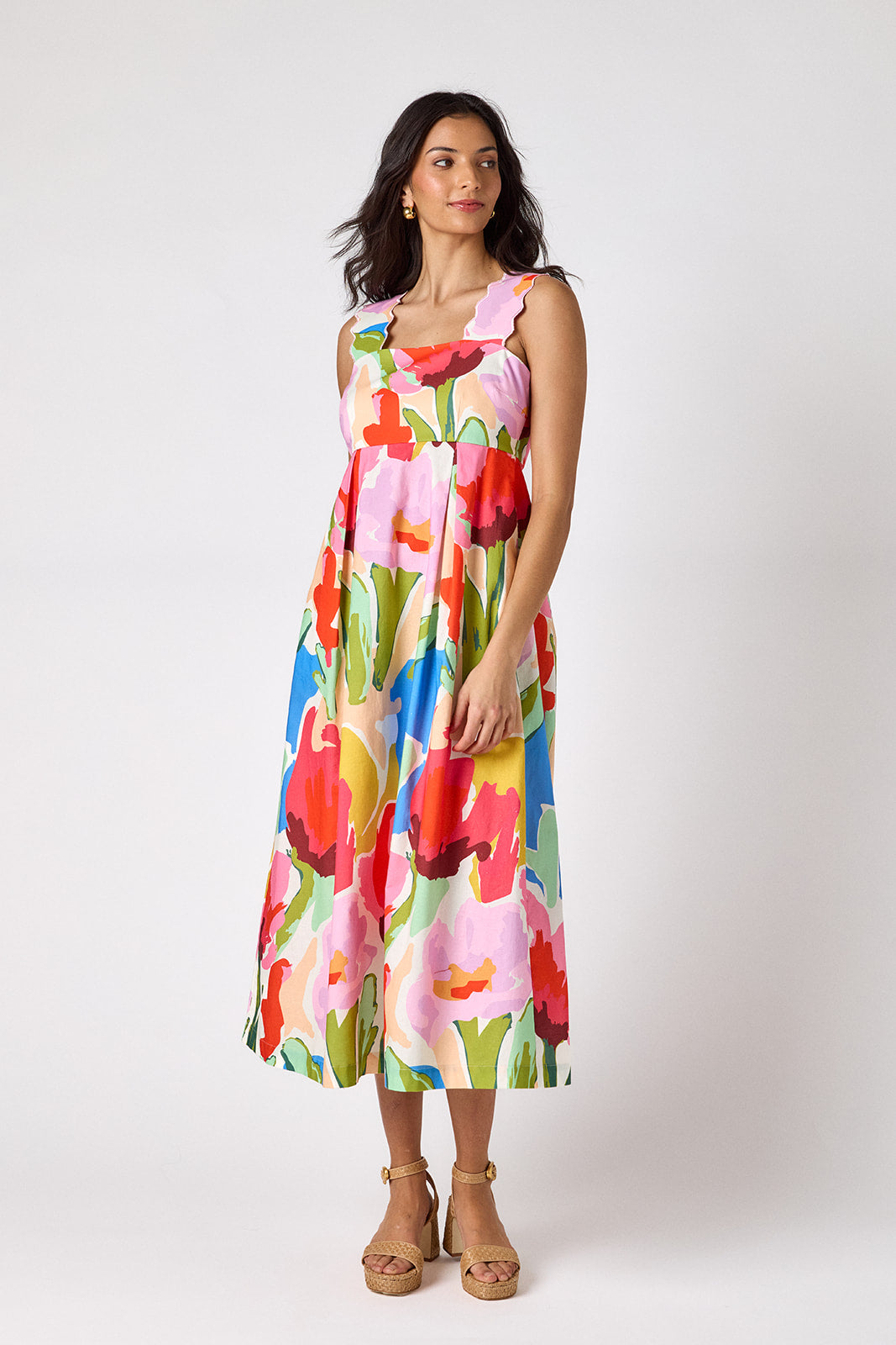 Painted Petals midi dress with fitted bodice and wavy straps on model — CROSBY by Mollie Burch