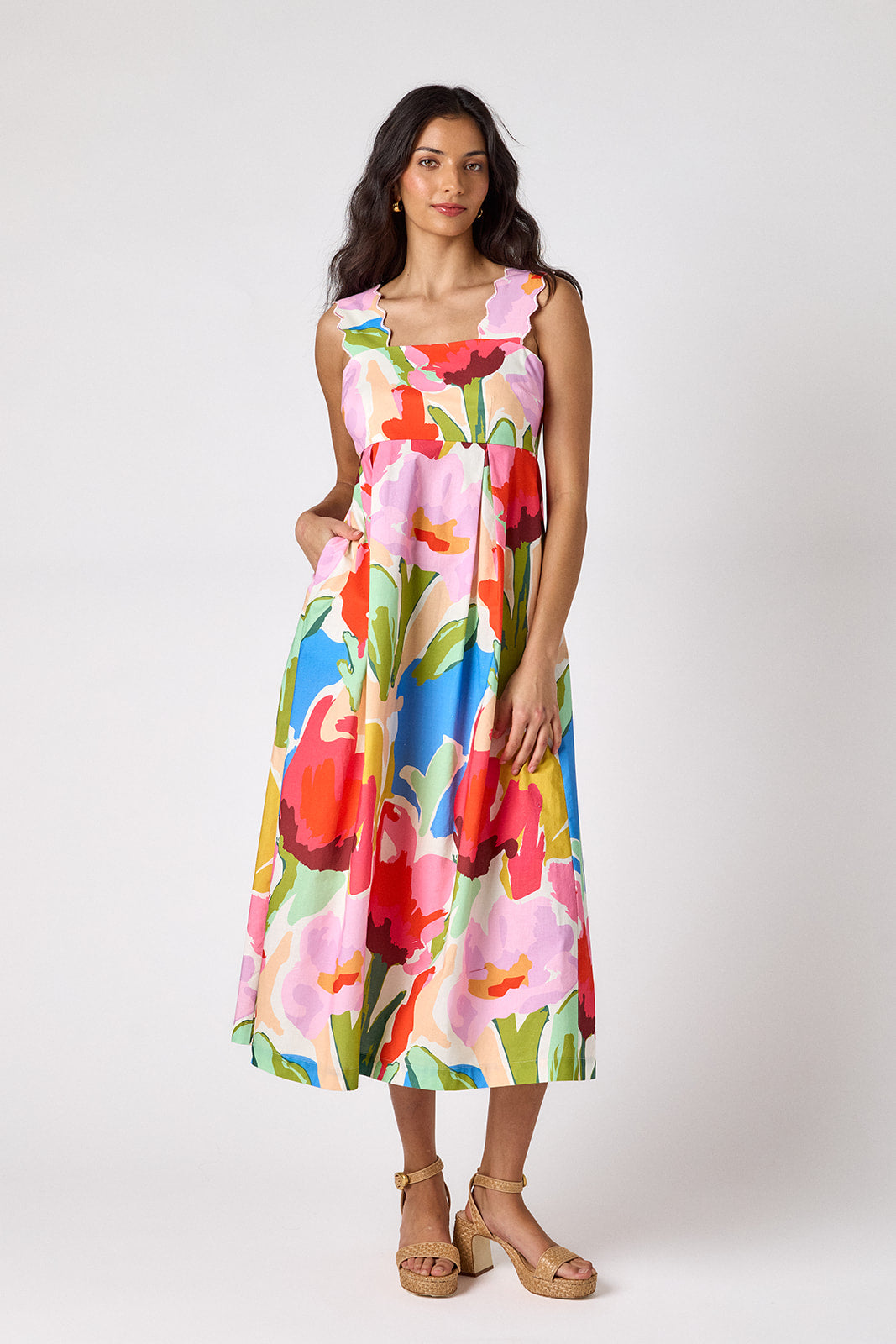 Painted Petals midi dress with fitted bodice and wavy straps on model — CROSBY by Mollie Burch