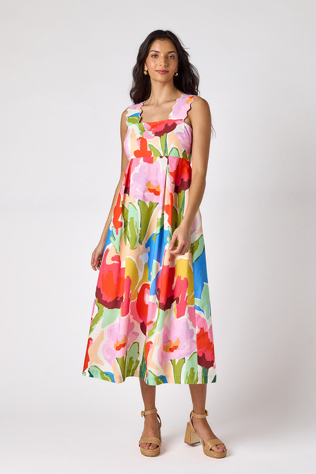 Painted Petals midi dress with fitted bodice and wavy straps on model — CROSBY by Mollie Burch